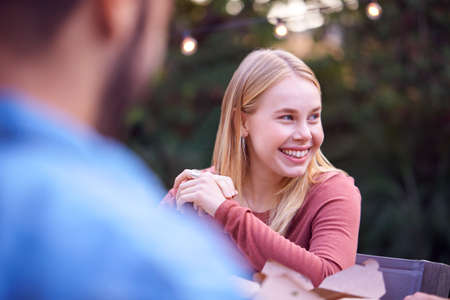 Woman In Garden At Home With Friends Enjoying Summer Garden Partyの写真素材