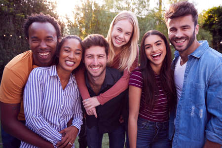 Portrait Of Group Of Multi-Cultural Friends Enjoying Outdoor Summer Garden Partyの写真素材