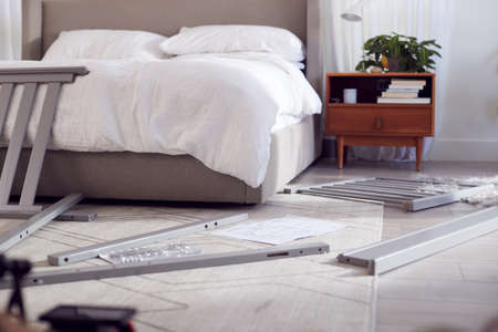 Instructions And Components For Self Assembly Baby Cot On Bedroom Floorの写真素材