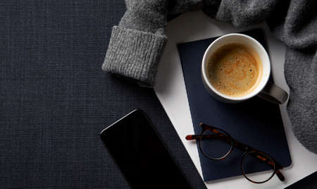 Flat Lay Lifestyle Shot With Jumper Cosmetics Notebook And Handbag On Black Backgroundの写真素材