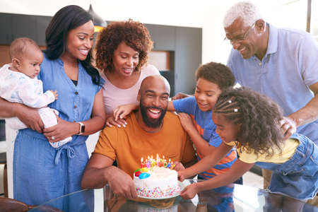 Multi-Generation African American Family Celebrating Fathers Birthday At Home Togetherの写真素材