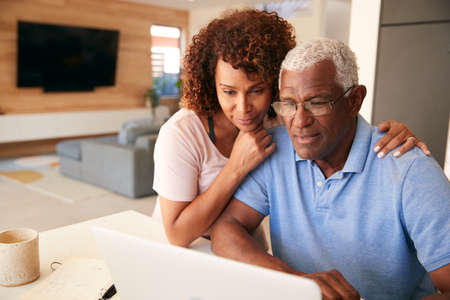 Senior African American Couple Using Laptop To Check Finances At Homeの写真素材