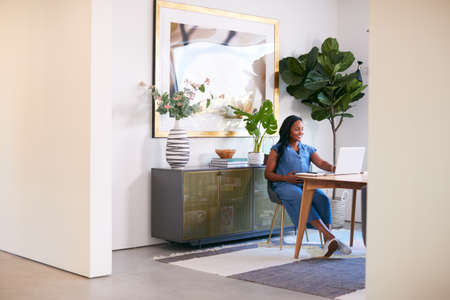 Pregnant African American Woman Using Laptop At Table Working From Home