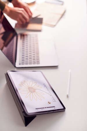 Close Up Of Desk Of Graphic Designer With Image Drawn On Digital Tabletの写真素材