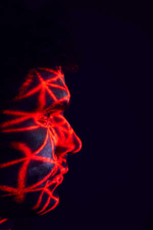 Facial Recognition Technology Concept As Man Has Red Grid Projected Onto Face In Studioの写真素材