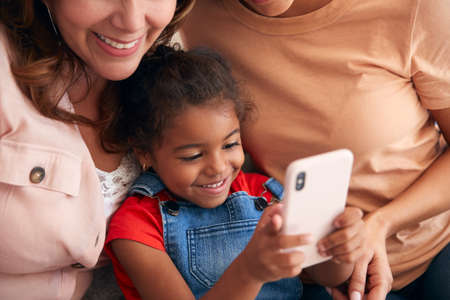 Close Up Of Multi-Generation Female Hispanic Family At Home Posing For Selfie On Mobile Phone