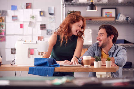 Male And Female Students Or Business Owners Working In Fashion Having Meeting In Studioの写真素材