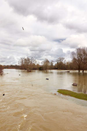 Benches Submerged As River Thames Floods And Bursts In Banks In UKの写真素材