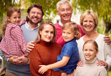Portrait Of Smiling Multi-Generation Family At Home In Garden Togetherの写真素材