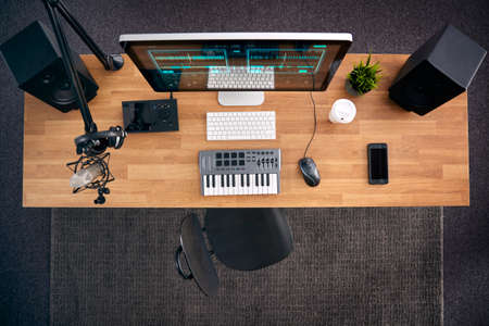 Overhead View Of Music Workstation With Keyboard And Microphone In Studioの写真素材