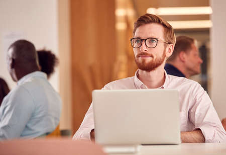 Businessman With Laptop Working On Table In Office Coffee Shopの写真素材