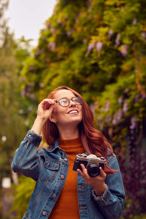 Young Woman In City Taking Photo On Digital Camera To Post To Social Mediaの写真素材