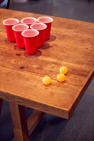 Plastic Cups And Balls On Wooden Table Ready For Party Game At Homeの写真素材