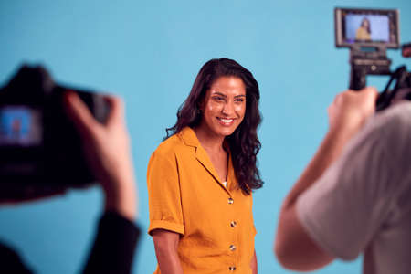 Mature Woman In Studio On Shoot With Video And Stills Camera