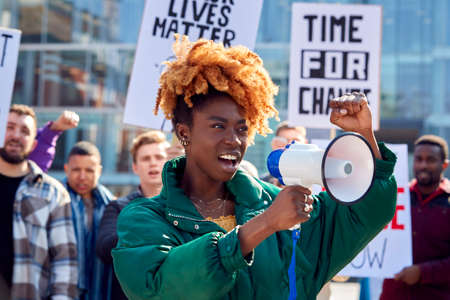 Protestors With Placards And Megaphone On Black Lives Matter Demonstration March Against Racismの写真素材