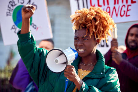 Group Of Protestors With Placards And Megaphone On Demonstration March Against Climate Changeの写真素材