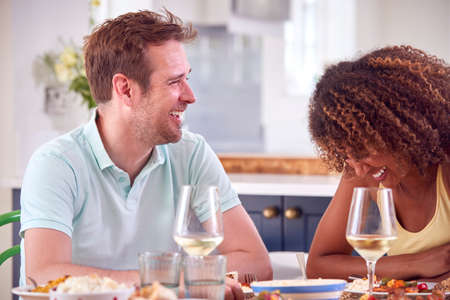 Couple Enjoying Romantic Meal At Home On Date Night Togetherの写真素材