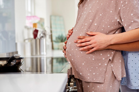 Close Up Of Same Sex Couple With Woman Holding Pregnant Partners Stomach At Homeの写真素材