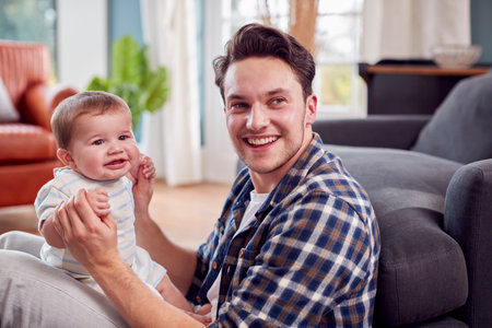 Loving Transgender Father Playing With Baby Son Sitting On Floor At Home