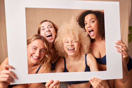 Group Of Body Positive Women Friends In Underwear Pulling Faces In Picture Frameの写真素材