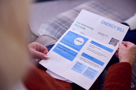 Close Up Of Senior Woman At Home Looking At Energy Bill During Cost Of Living Energy Crisis