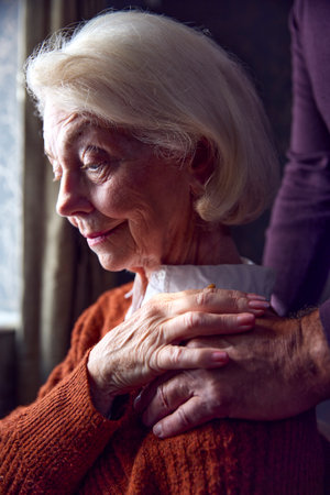 Close Up Of Senior Couple At Home With Man Putting Reassuring Hand On Woman's Shoulderの写真素材