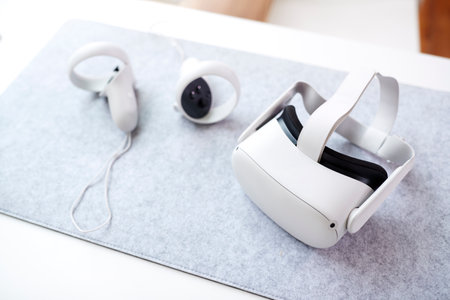 VR Headset And Gaming Controllers On Table At Home