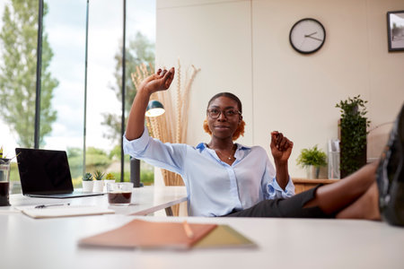 Woman Working From Home Office Sitting At Desk Interacting With AR Technologyの写真素材