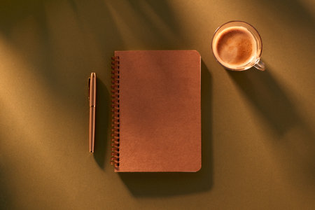 Overhead Flat Lay Holiday Vacation Shot Of Notepad With Pen And Cup Of Coffeeの写真素材