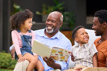 Smiling Multi-Generation Family Reading Book In Garden Togetherの写真素材