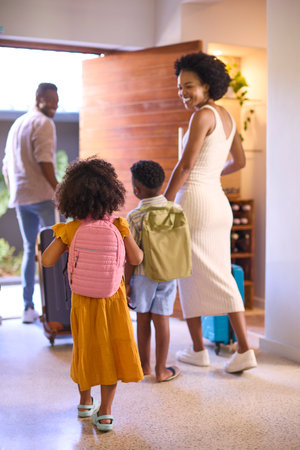 Family By Door With Suitcases Leaving Home For Holiday Or Vacationの写真素材