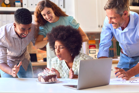 Staff Celebrating Birthday Of Female Colleague In Architects Office With Cakeの写真素材