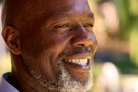 Portrait Of Smiling Senior Man Standing Outdoors In Garden Park Or Countrysideの写真素材
