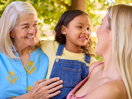 Portrait Of Smiling Multi-Generation Female Family In Garden Together Together