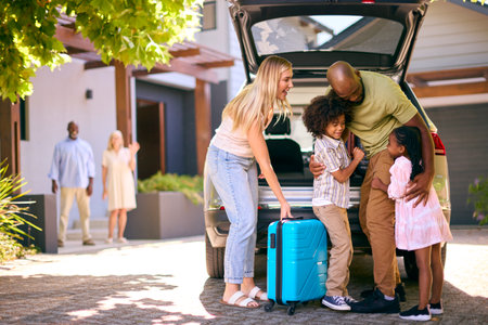 Family Loading Car And Saying Goodbye After Visit To Grandparentsの写真素材