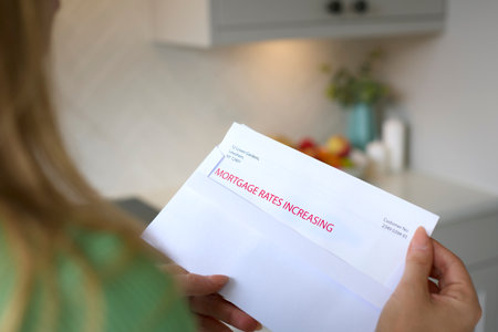 Close Up Of Woman Opening Letter About Increase in Mortgage Rate During Cost Of Living Crisisの写真素材