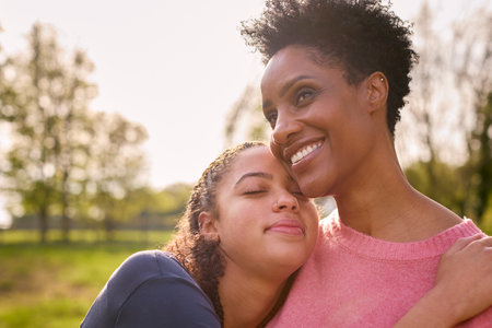 Loving Mature Mother With Teenage Daughter Enjoying Walk In Countryside Togetherの写真素材