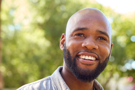 Portrait Of Smiling Man Standing Outdoors In Garden Park Or Countryside