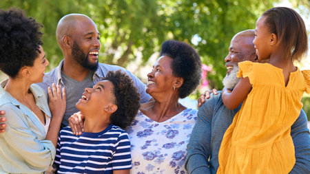 Portrait Of Multi-Generation Family Standing Outdoors In Garden Or Countryside Smiling At Cameraの写真素材