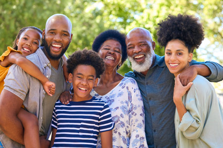 Portrait Of Multi-Generation Family Standing Outdoors In Garden Or Countryside Smiling At Cameraの写真素材