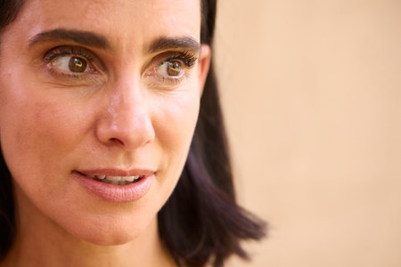 Close Up Beauty Portrait Of Smiling Mature Woman Against Natural Backgroundの写真素材