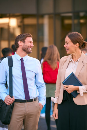 Male And Female Secondary Or High School Teachers Outside School Building With Studentsの写真素材