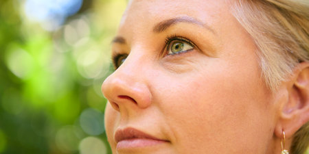 Close Up On Face Of Confident Mature Woman With Short Hair Standing Outdoorsの写真素材
