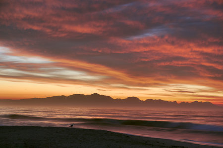 Beautiful Sunrise Morning Over Beach And Sea Looking Towards Mountains In South Africaの写真素材