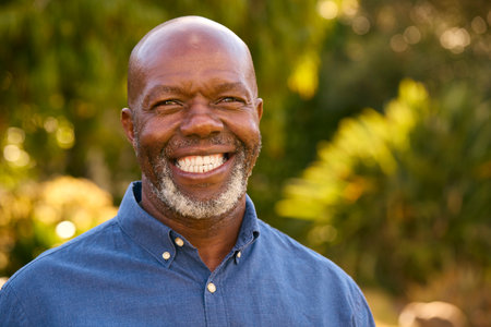 Portrait Of Smiling And Laughing Senior Man Outdoors In Countryside Or Garden