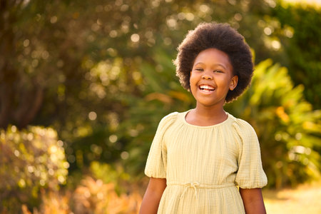 Smiling And Laughing Young Girl Outdoors In Countryside Or Gardenの写真素材