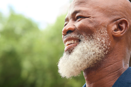 Close Up Portrait Of Smiling Senior Man Outdoors In Countryside Or Gardenの写真素材