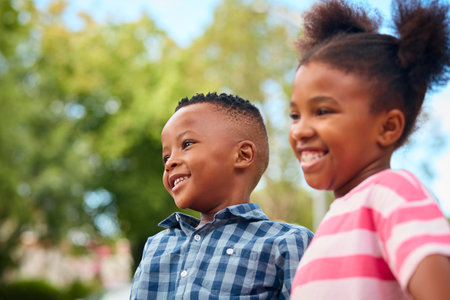 Close Up Of Smiling And Laughing Young Boy And Girl Hugging Outdoors In Countryside Or Gardenの写真素材
