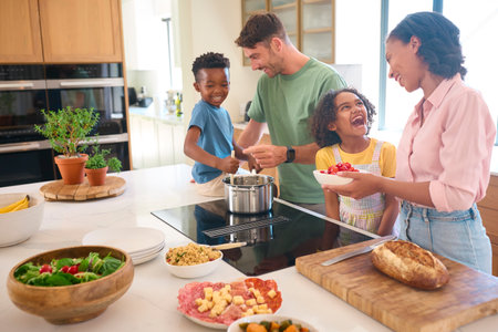 Multi-Racial Family Preparing Meal In Kitchen At Home Togetherの写真素材