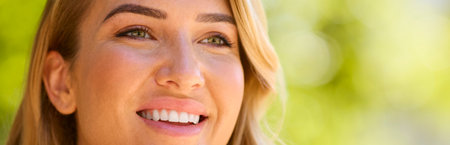 Close Up Portrait Of Smiling Woman's Face Outside Relaxing In Countrysideの写真素材